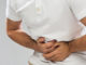 person holding stomach in pain epigenetics