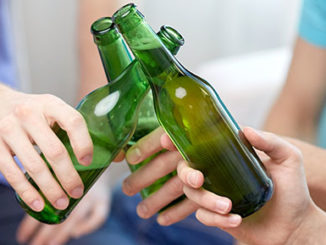 Three people holding beer bottles cheersing epigenetics